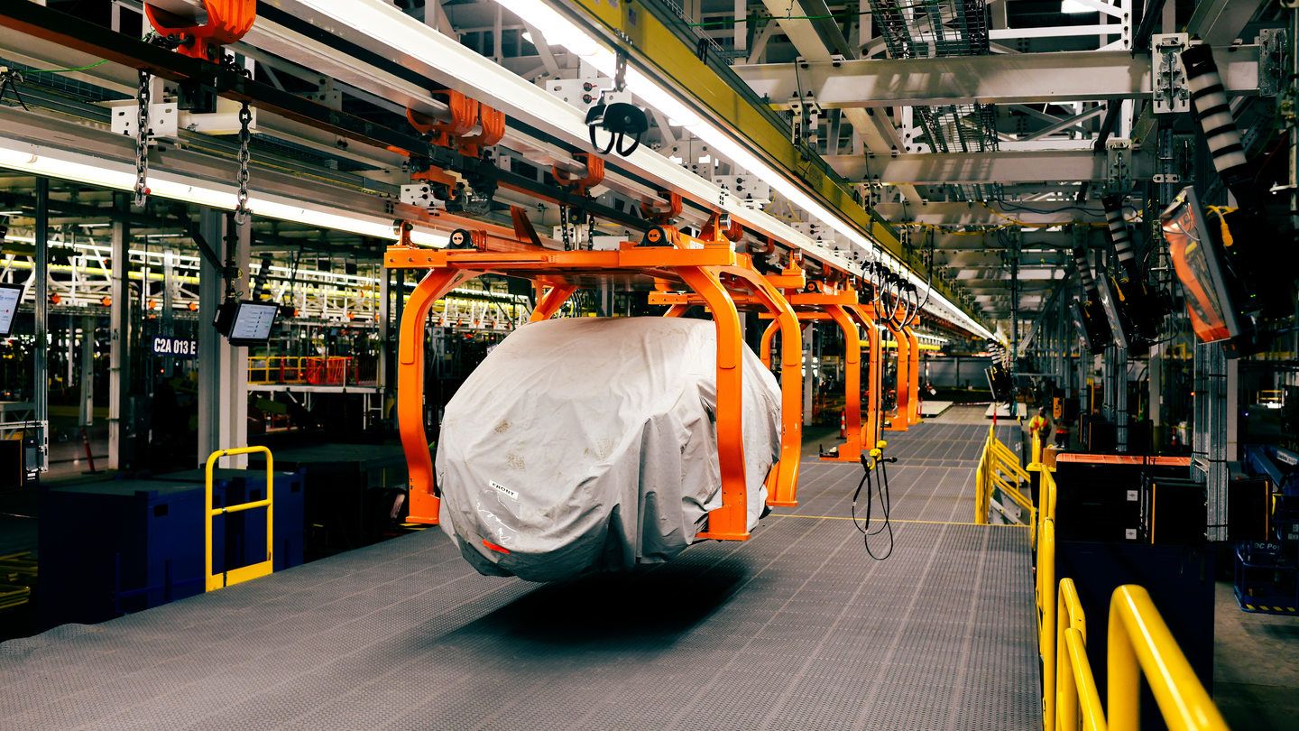 2028 Ford Fathom - a covered Ford Fathom prototype on an overhead assembly line conveyor in the factory - Mayfield Ford - Ford new car dealership in Brampton, Ontario