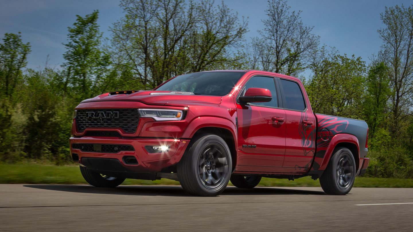 2027 Ram 1500 Rumble Bee - a red 2027 Ram 1500 Rumble Bee truck driving along a road - Cooksville Dodge - Ram car dealership in Mississauga, Ontario