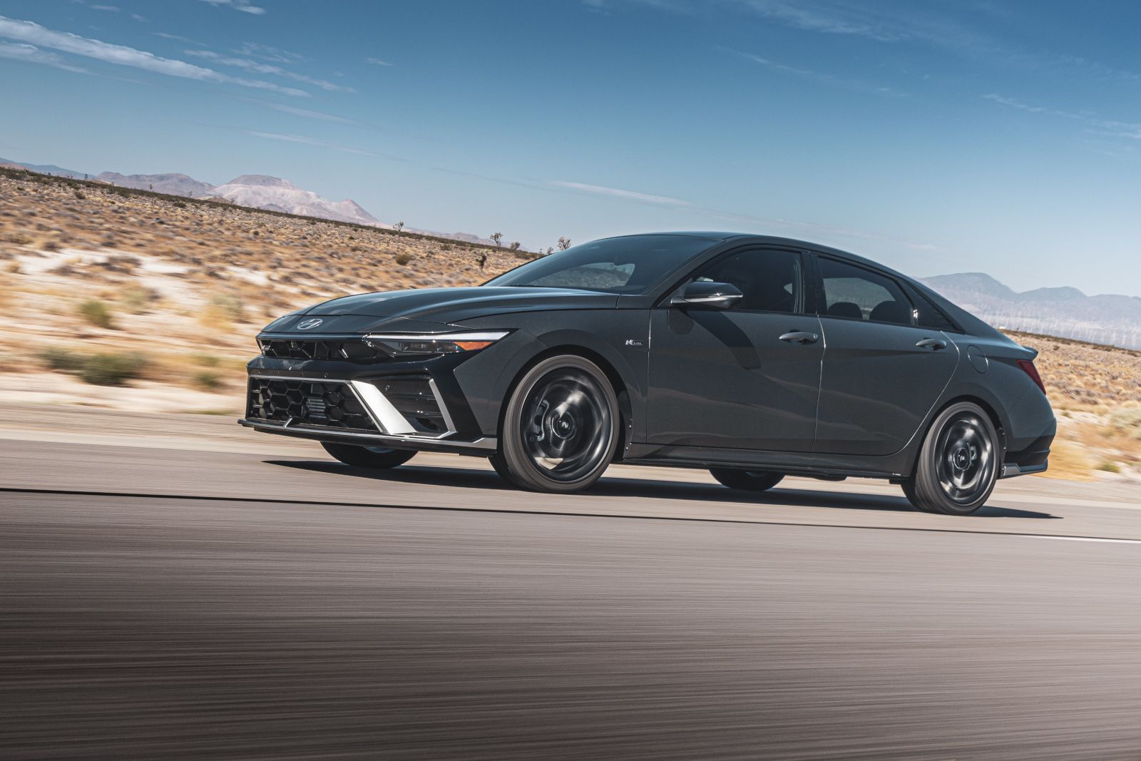 2026 Hyundai Elantra - 2026 Hyundai Elantra driving at speed on a desert highway - Cooksville Hyundai - Hyundai new car dealership in Mississauga, ON