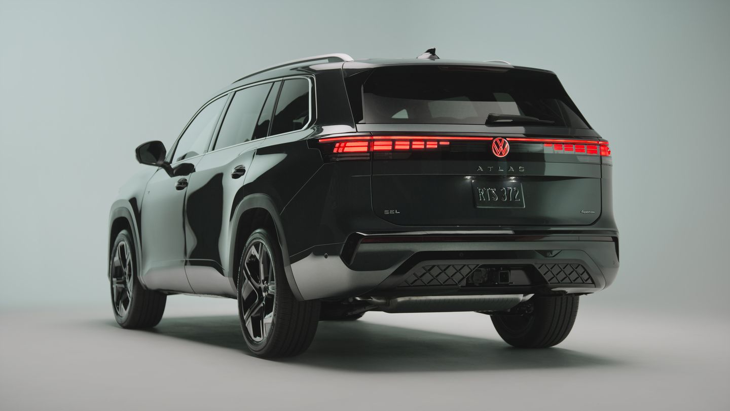 2027 Volkswagen Atlas - rear three-quarter studio shot of a dark green Atlas SEL with illuminated LED lightbar and logo - Humberview Volkswagen - New car dealership in Toronto, Ontario