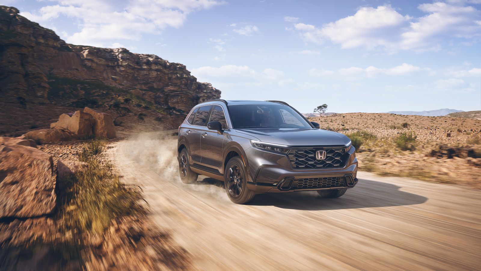 2026 Honda CR-V - a grey 2026 Honda CR-V driving on a dusty dirt road in the desert - Goderich Honda - Honda new car dealership in Goderich, Ontario