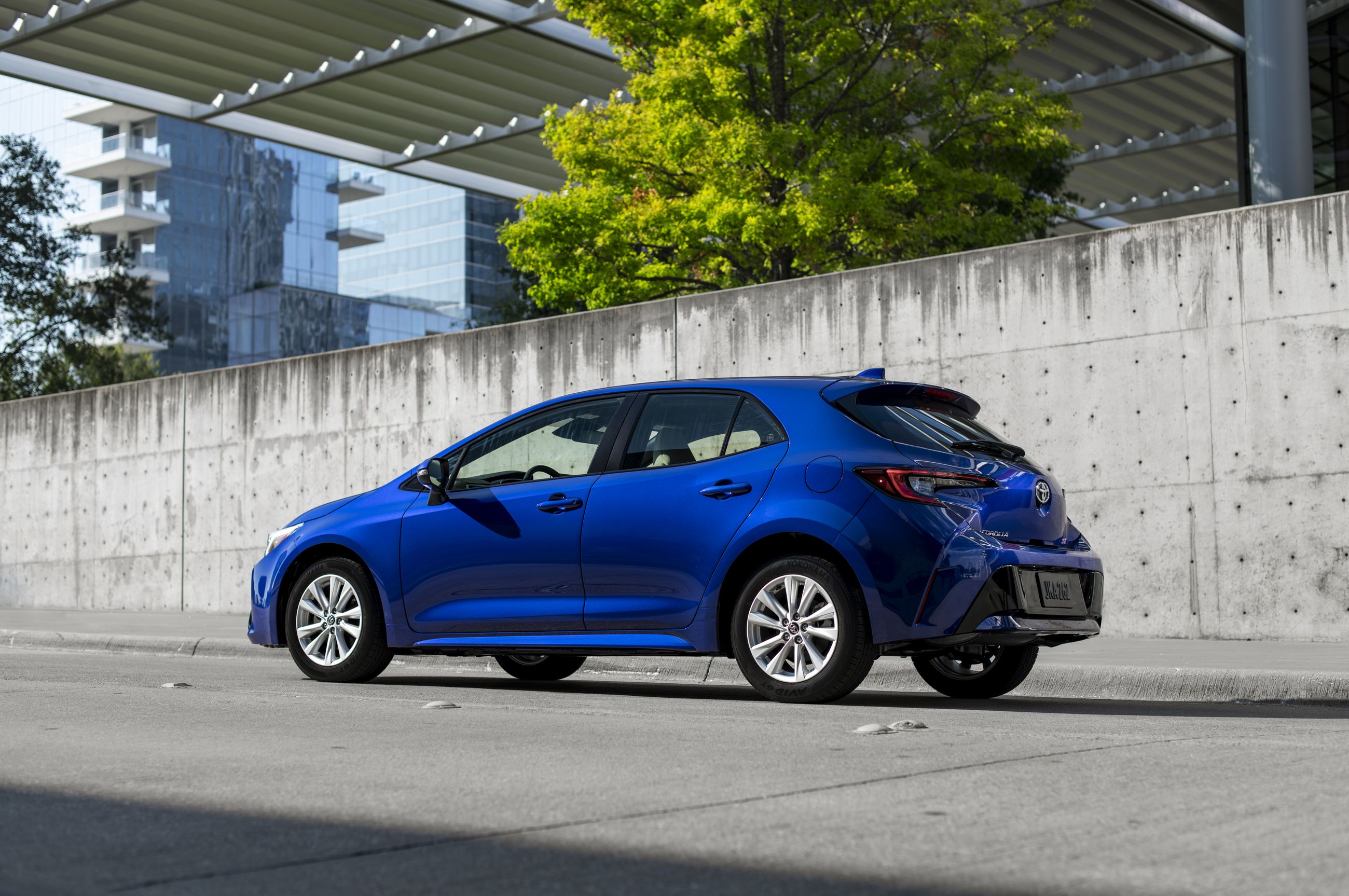 2026 Toyota Corolla - rear three-quarter profile of a blue 2026 Toyota Corolla hatchback parked in front of a modern concrete wall - Humberview Group - New car dealerships in Ontario