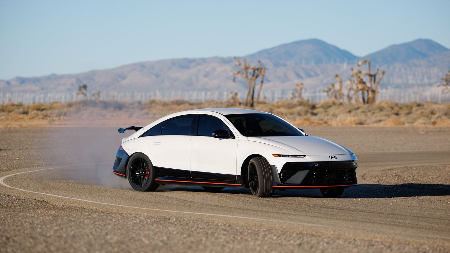 2027 Hyundai Ioniq 6 N - a white 2027 Hyundai Ioniq 6 N drifting on an open test track in the desert - Humberview Group - New car dealerships in Ontario