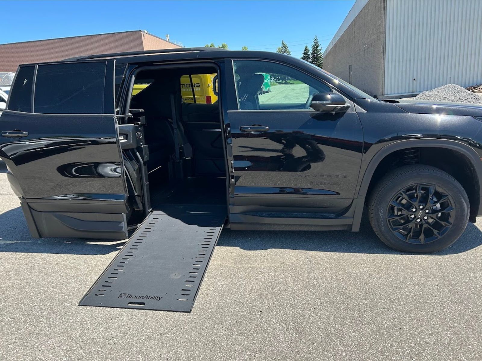 2026 Chevrolet Traverse - side profile view of a black 2026 Chevrolet Traverse showing an extended BraunAbility side-entry ramp - Humberview Mobility - Accessible car dealership in Toronto, Ontario