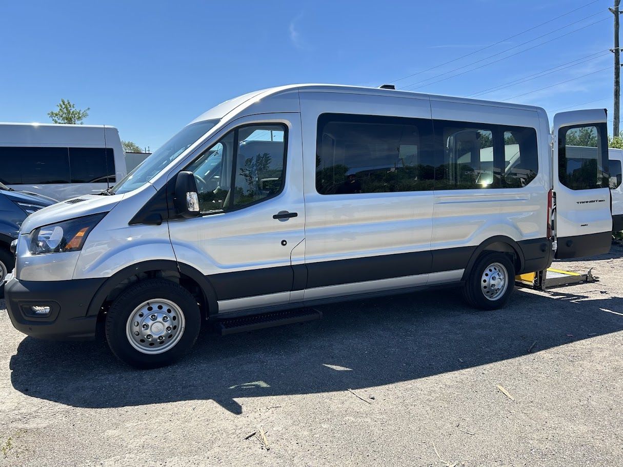 2026 Ford Transit - a silver 2026 Ford Transit van with its rear doors open and a rear-entry wheelchair lift deployed - Humberview Mobility - Accessible car dealership in Toronto, Ontario