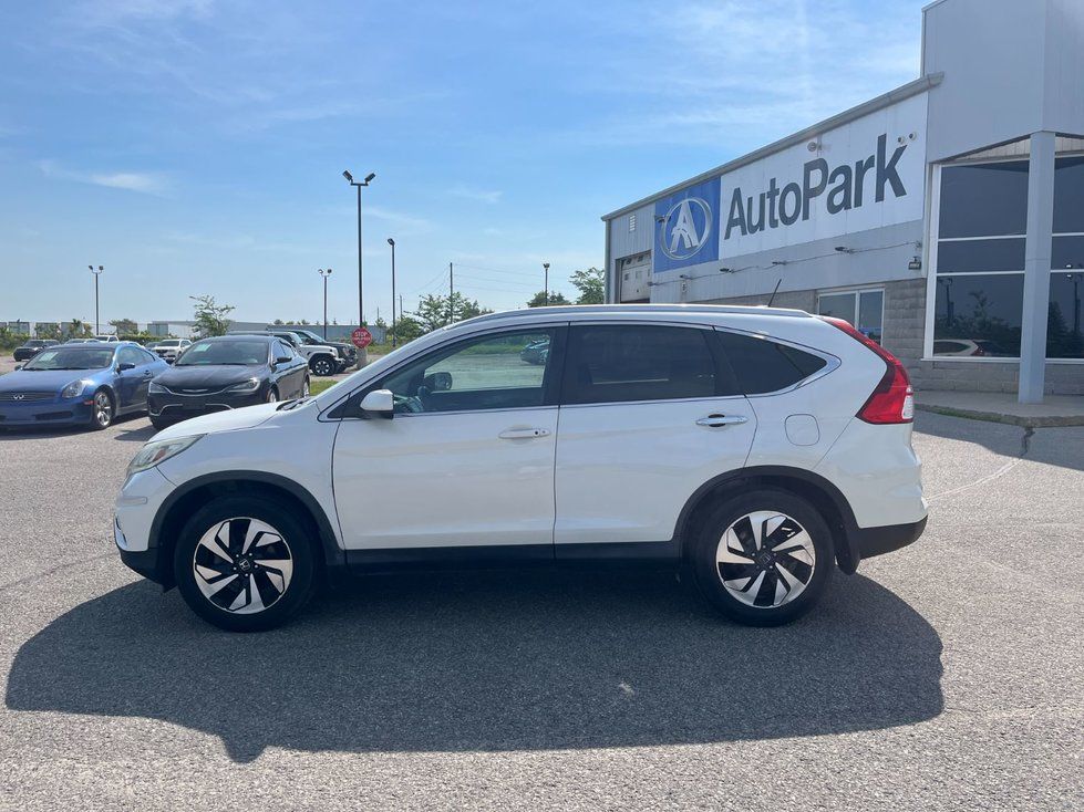 Honda CR-V - side profile view of a white Honda CR-V parked outside the showroom - AutoPark Barrie - Used car dealership in Barrie, Ontario