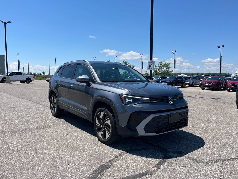 Volkswagen Taos - front three-quarter view of a grey Volkswagen Taos under a clear blue sky - AutoPark Barrie - Used car dealership in Barrie, Ontario