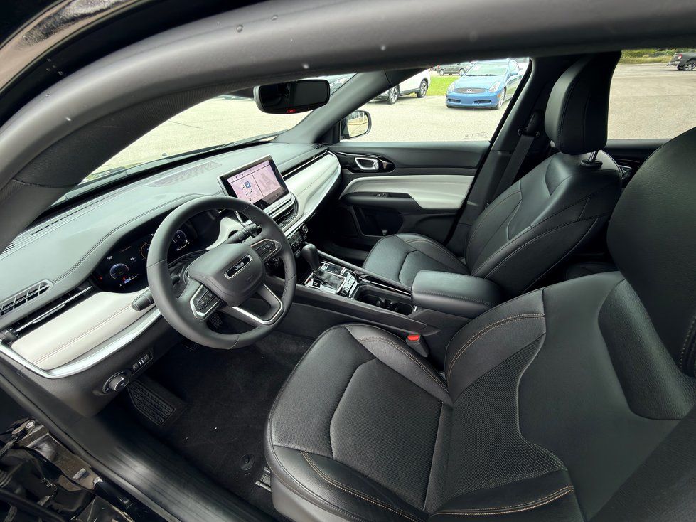Jeep Compass - interior view of the Jeep Compass front seats, steering wheel, and dashboard - AutoPark Barrie - Used car dealership in Barrie, Ontario
