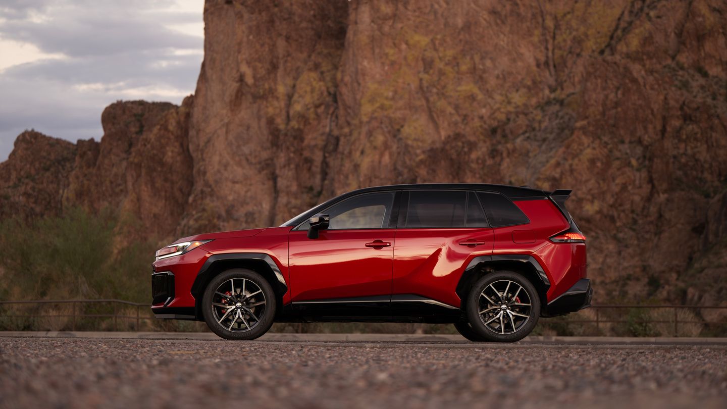 2026 Toyota RAV4 - side profile view of a red 2026 Toyota RAV4 parked in front of a rocky cliff - Georgetown Toyota - Toyota car dealership in Georgetown, Ontario