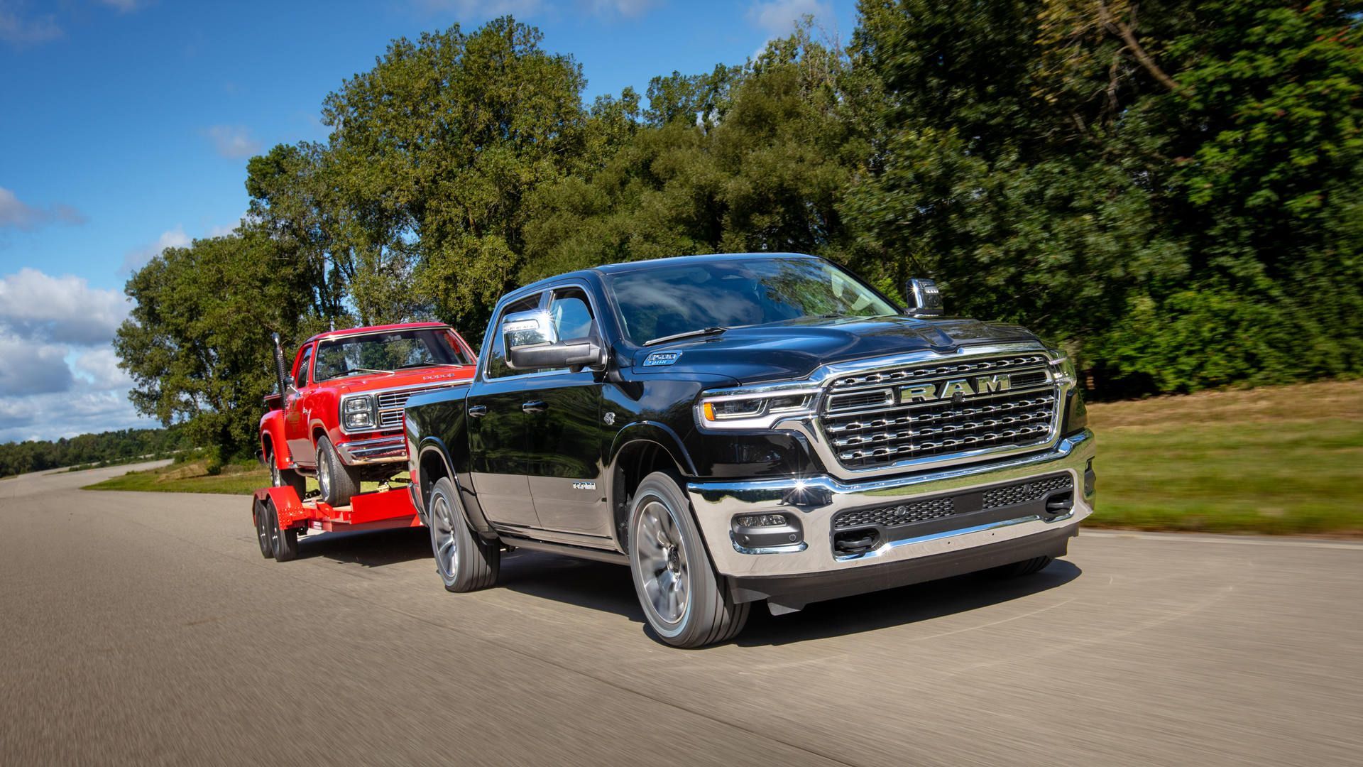 2027 Ram 1500 - A black Ram 1500 towing a flatbed trailer carrying a classic red truck - Cooksville Chrysler, Jeep, Dodge, Ram - Ram new car dealership in Mississauga, Ontario