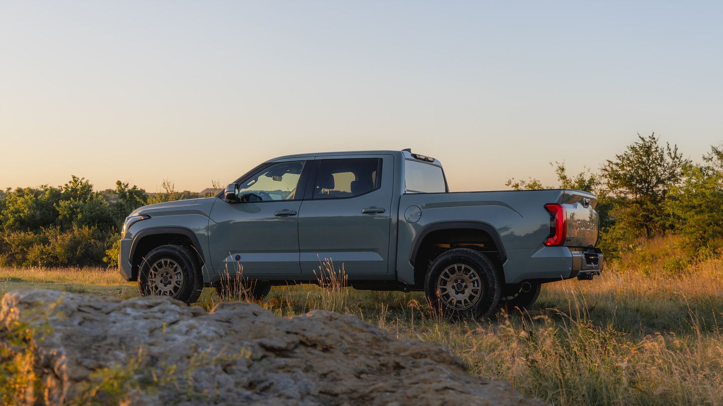 2027 Toyota Tundra - a rear side profile view of a grey 2027 Toyota Tundra truck parked in a grassy field - Goderich Toyota - Toyota new car dealership in Goderich, ON