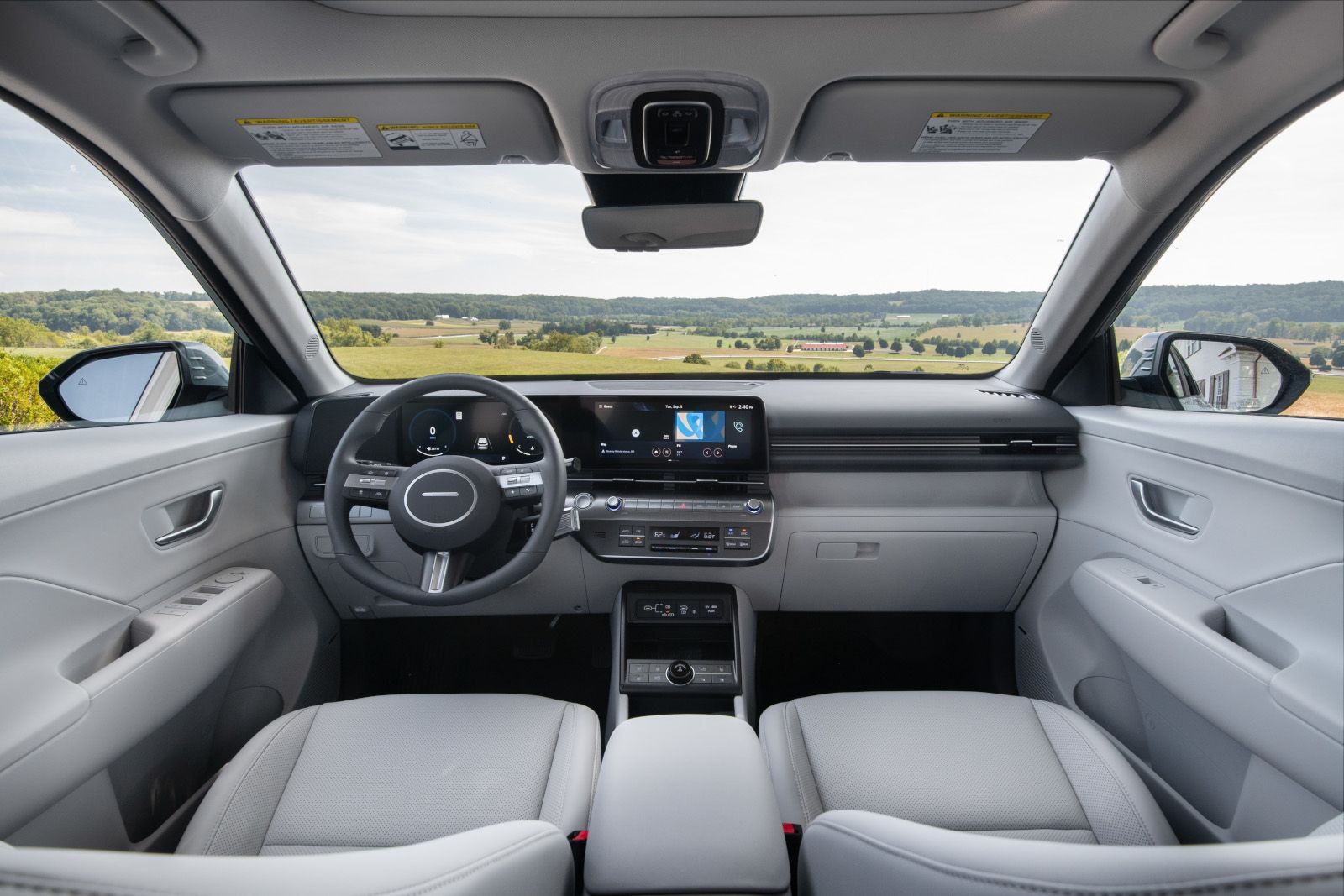 2027 Hyundai Kona - interior view of the 2027 Hyundai Kona front seats, dashboard, and infotainment display - Woodstock Hyundai - Hyundai new car dealership in Woodstock, Ontario