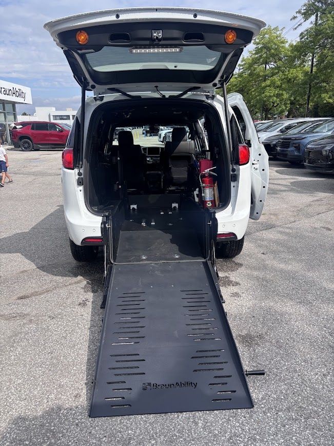 BraunAbility Chrysler Pacifica - rear view of a white BraunAbility Chrysler Pacifica with the tailgate open and the access ramp deployed - Humberview Mobility - Accessible car dealership in Toronto, Ontario