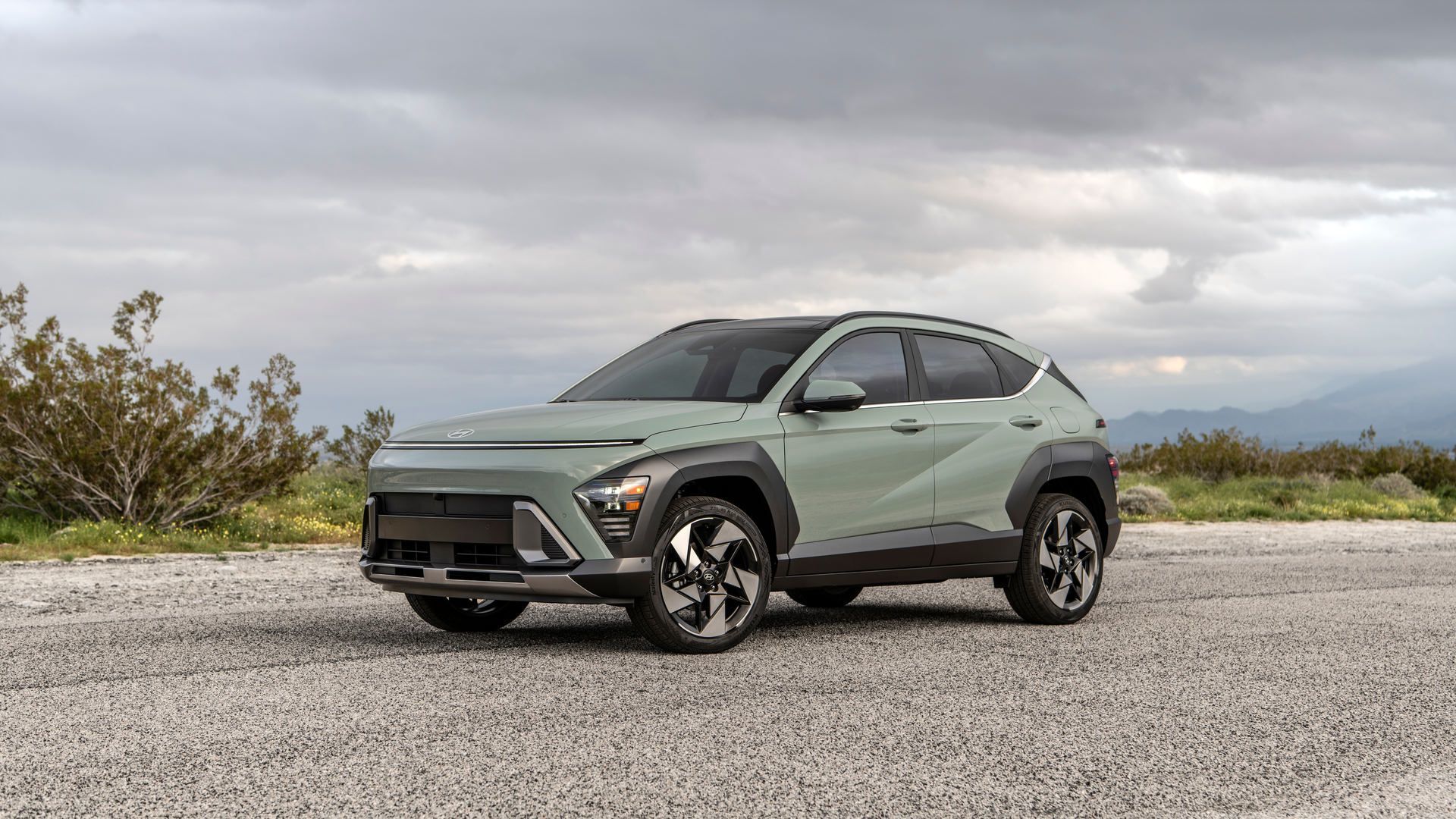 2027 Hyundai Kona - front three-quarter view of a sage green 2027 Hyundai Kona parked on a gravel road under an overcast sky - Humberview Group - New car dealerships in Ontario