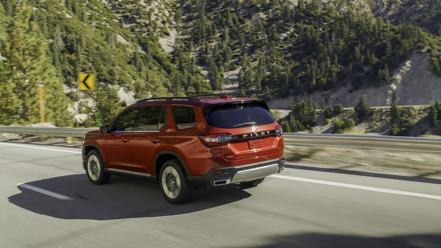 2027 Honda Pilot - a red 2027 Honda Pilot driving on a highway road - Orangeville Honda - Honda new car dealership in Orangeville, Ontario