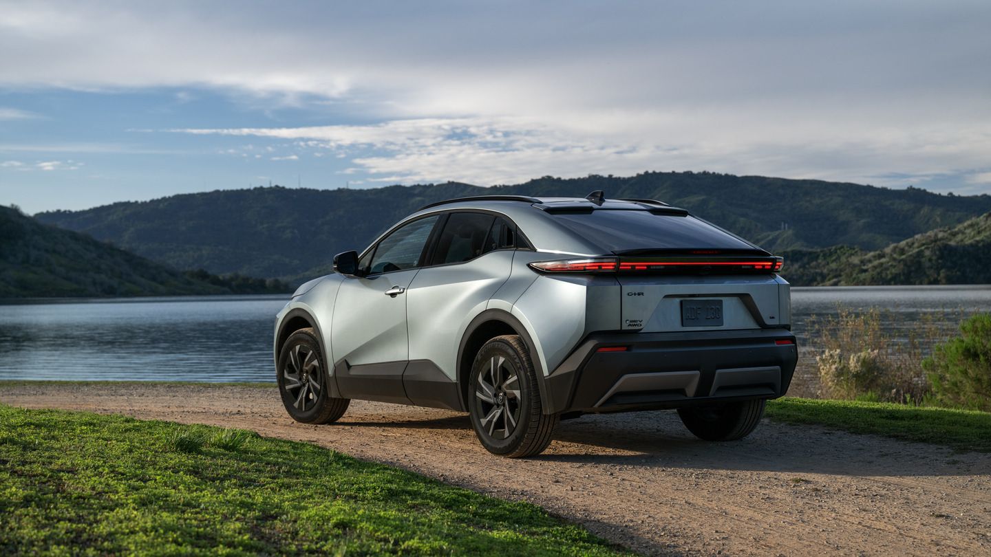 2027 Toyota C-HR - rear view of a silver 2027 Toyota C-HR on a dirt path next to a lake - Georgetown Toyota - Toyota car dealership in Georgetown, Ontario