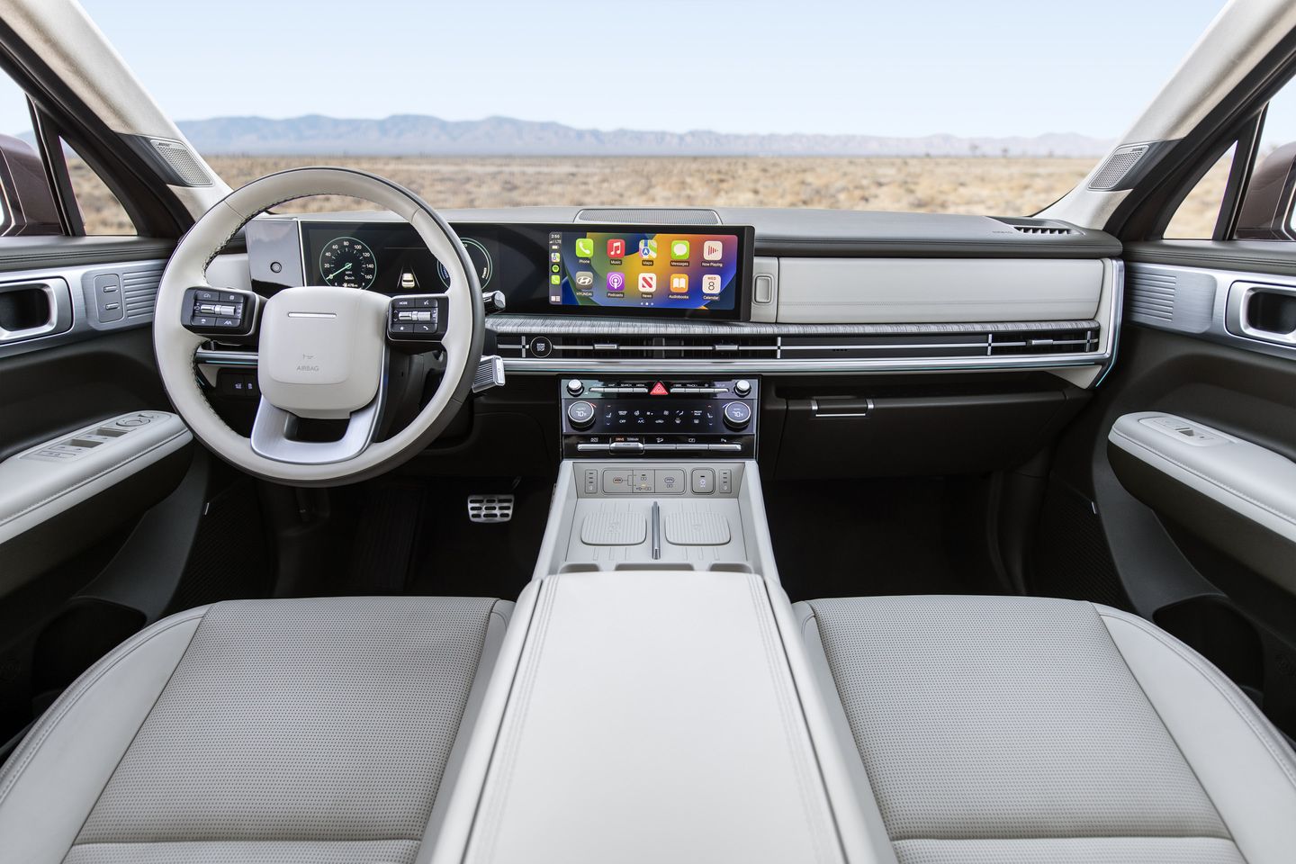 2027 Hyundai Santa Fe - interior view of the dashboard, steering wheel, and dual infotainment displays - Woodstock Hyundai - New car dealership in Woodstock, Ontario