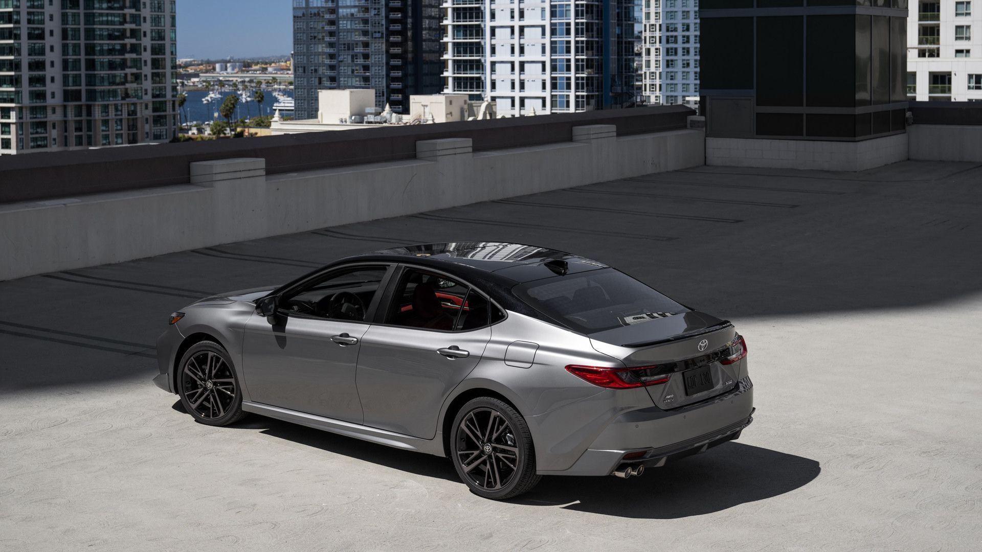 2027 Toyota Camry - elevated rear angle view of a silver Toyota Camry XSE with a black roof parked on an open rooftop - Oakville Toyota - Toyota new car dealership in Oakville, Ontario