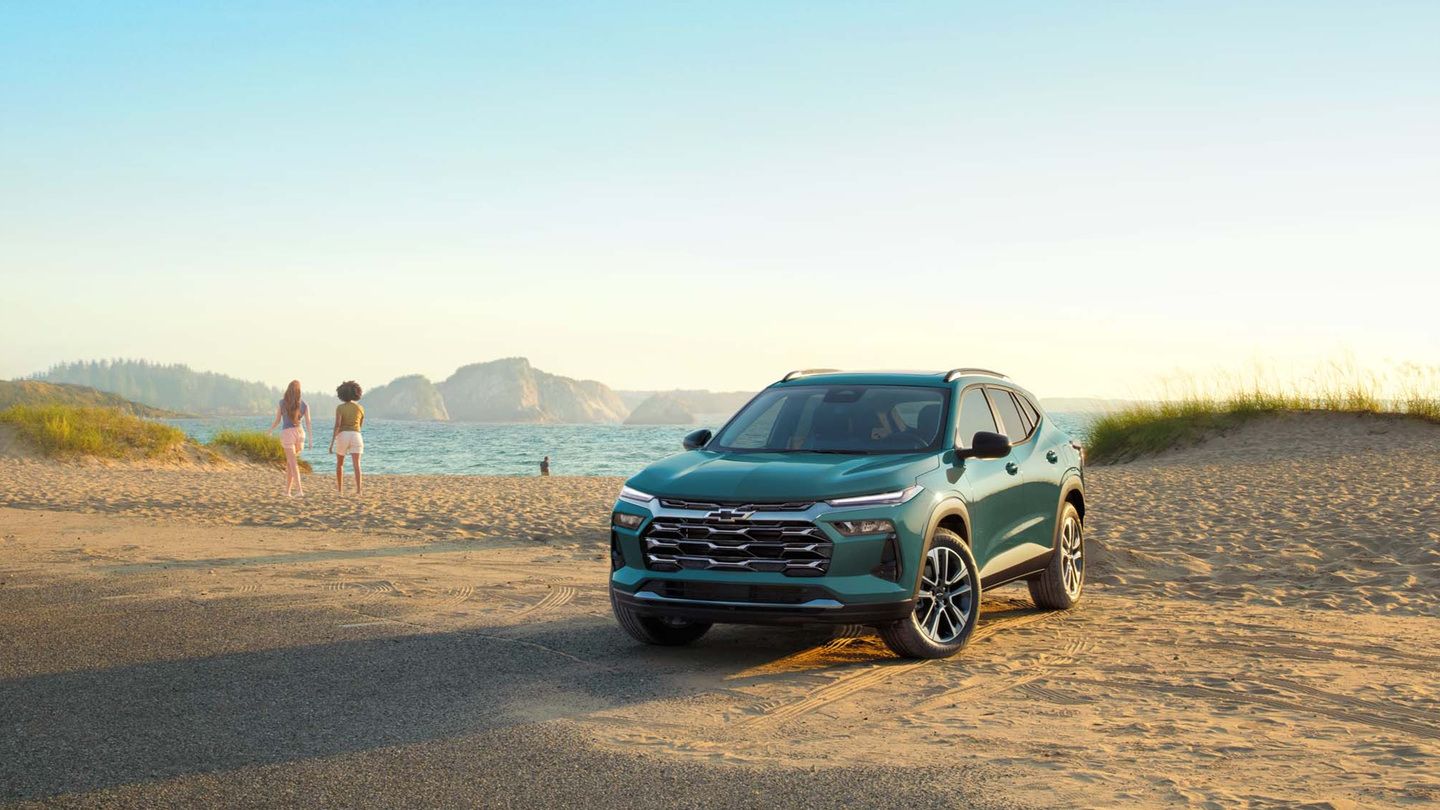 2027 Chevrolet Trax - front view of a teal 2027 Chevrolet Trax parked on a beach at sunset - Humberview Group - New car dealerships in Ontario