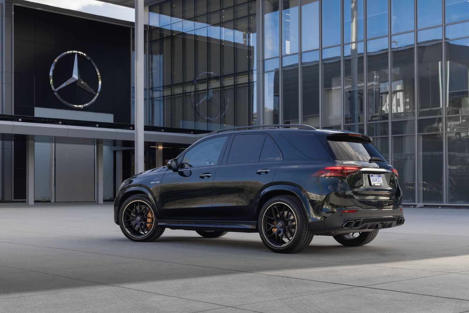 2027 Mercedes-Benz GLE SUV - rear three-quarter view of a black 2027 Mercedes-Benz GLE SUV parked outside a Mercedes-Benz showroom - Mercedes-Benz Brampton - New car dealership in Brampton, Ontario