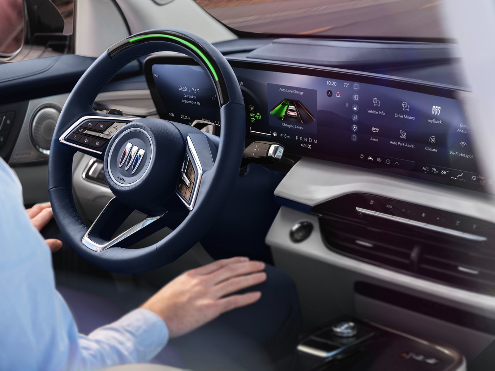 Close-up view of a modern Buick steering wheel, with digital screens displaying advanced driving and safety information, including an automatic lane change feature.