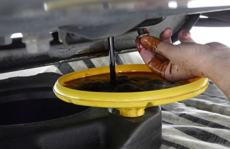 A technician changing oil