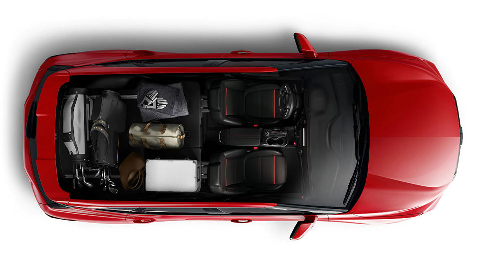 Image of a red 2021 Chevrolet Blazer from above. The interior can be seen, featuring ample storage space. Chevrolet Blazer 2021. Mid-size SUV. New Chevrolet. Used car for sale. Sept-Îles Chevrolet Buick GMC. North Shore dealership. All-wheel drive. Adventure vehicle. Towing capacity. Sporty driving.