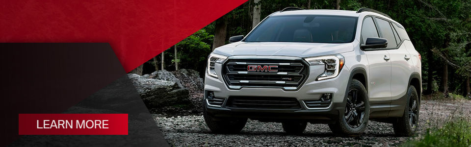 The best large-capacity 2022 GMC Terrain SUV in black driving on the North Shore in summer