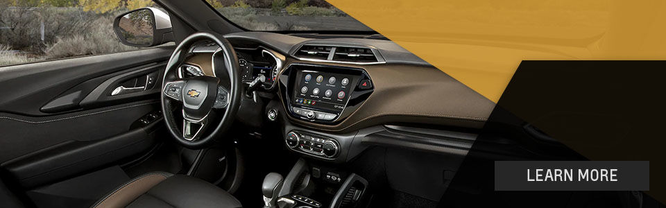 Interior image of the 2022 Chevrolet Trailblazer showing the steering wheel, touch screen and front accessories