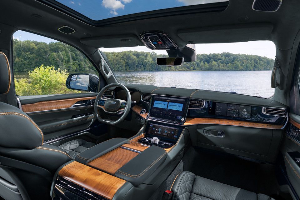 Interior view of the front seats, console and dashboard of a Jeep Grand Wagoneer