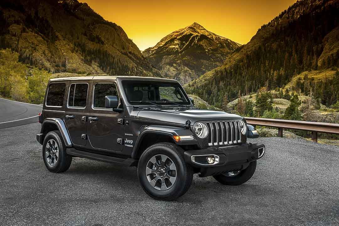 frontal side view of a Jeep Wrangler on a mountain road