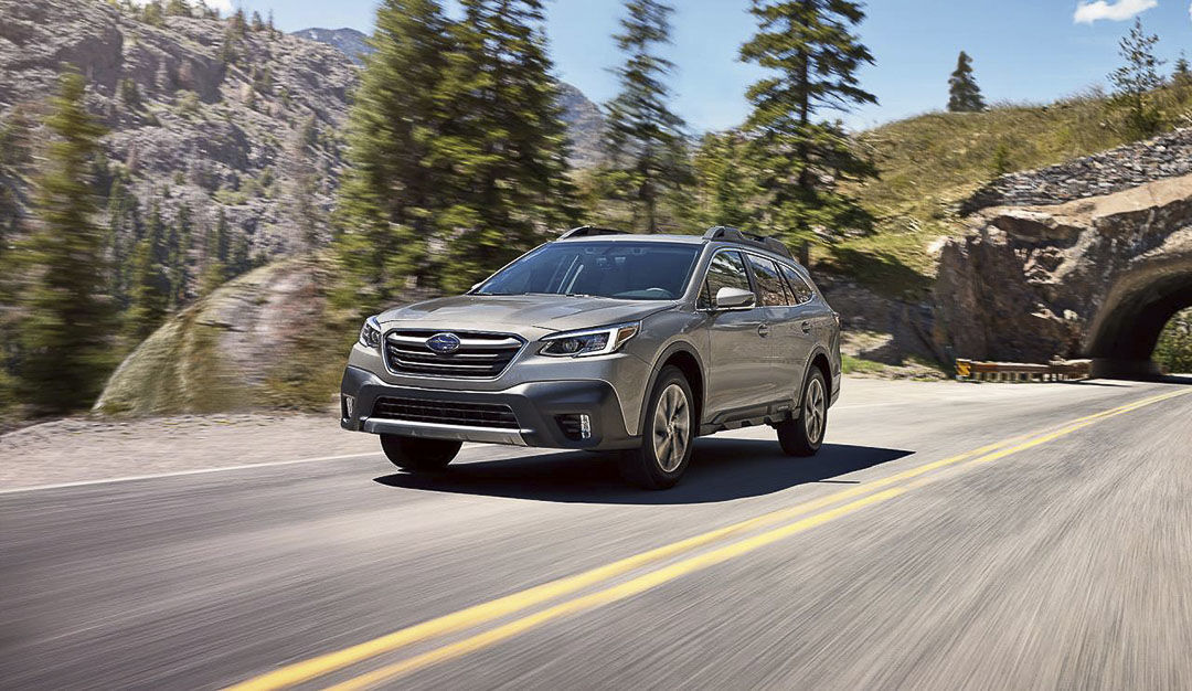 frontal side view of a Subaru outback on a mountain road