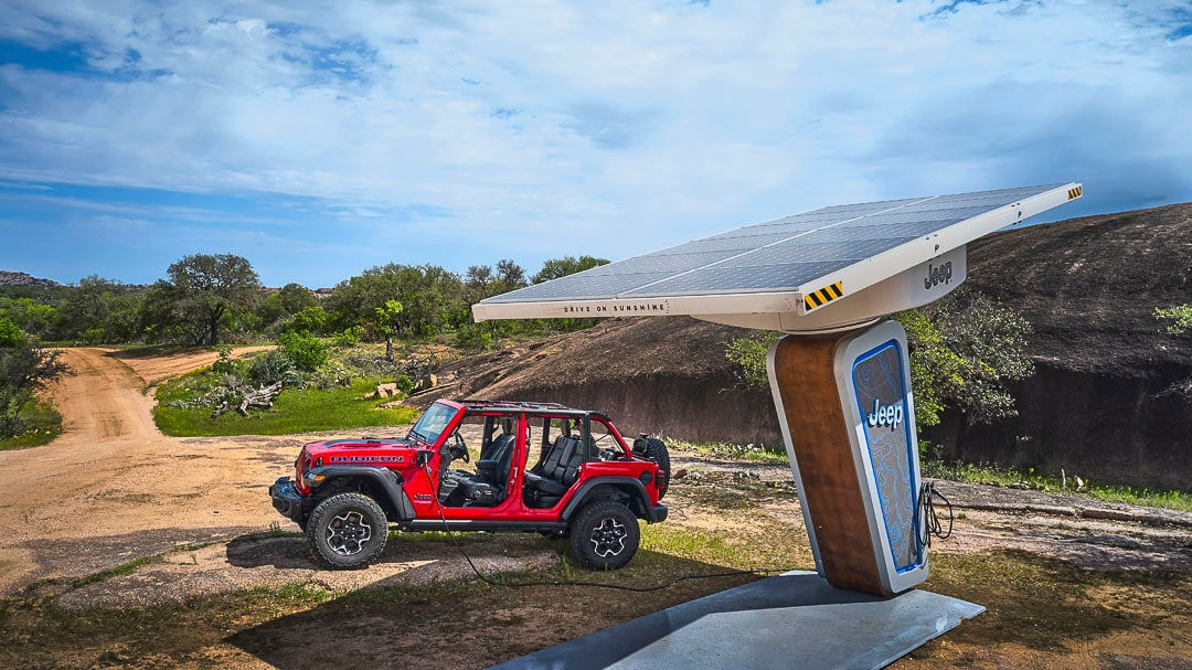 side view of a Jeep Wrangler at a charging station
