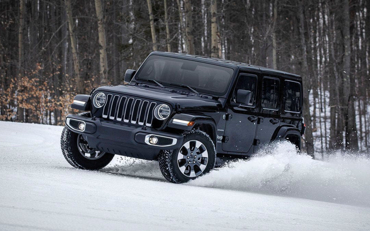 front side view of a 2022 Jeep Wrangler in the snow