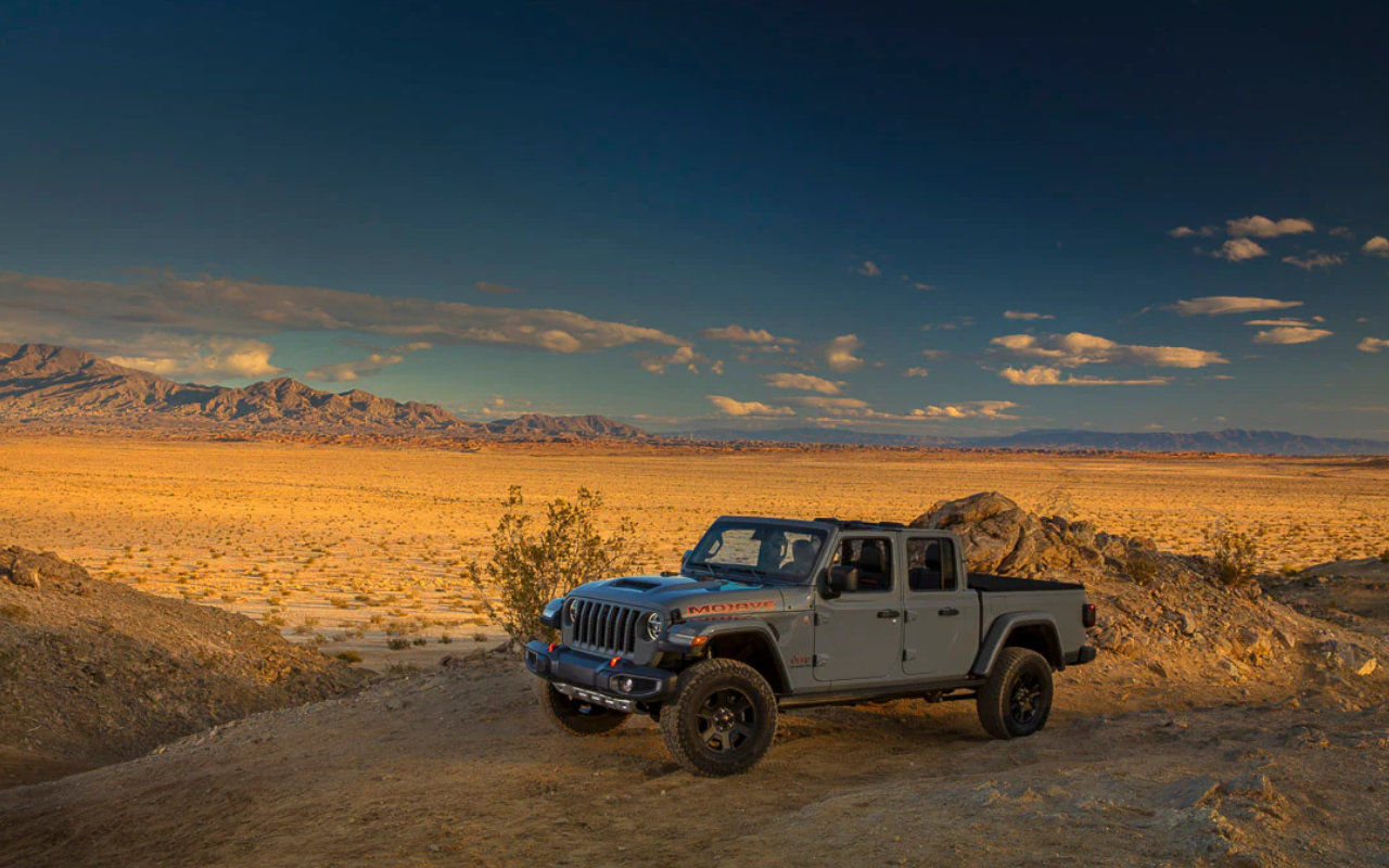 side view of a 2022 Jeep Gladiator in the desert at dusk