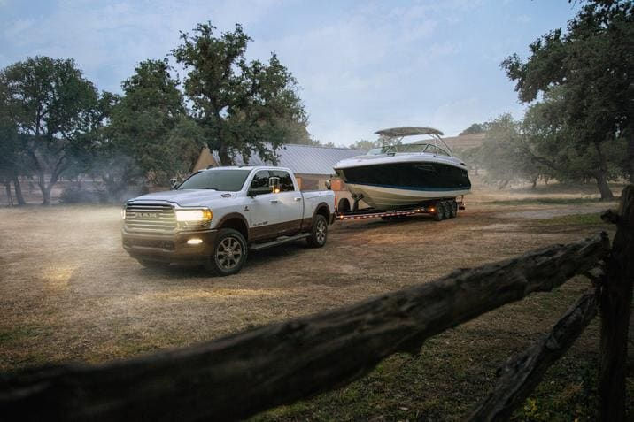 front side view of a 2020 RAM 1500 hitching a boat on a ranch