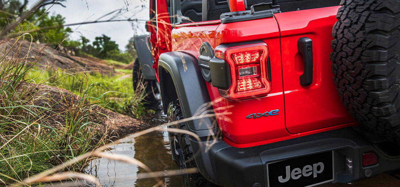 Close-up rear view of the Jeep Wrangler hybrid 4xe 2024 in a pool of water