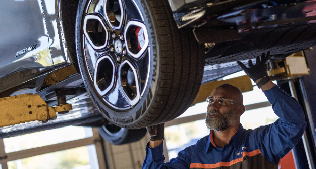 Quick Lane technician servicing a vehicle