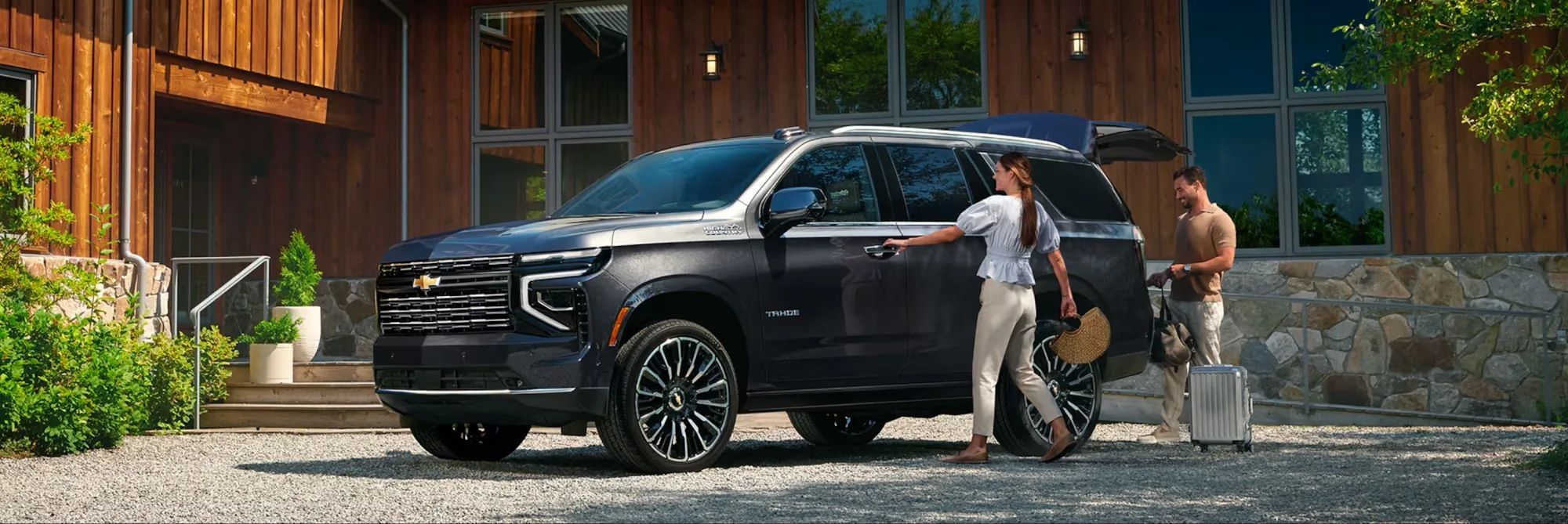 Chevrolet Tahoe 2026 in front of a home, illustrating Chevrolet models available after service.