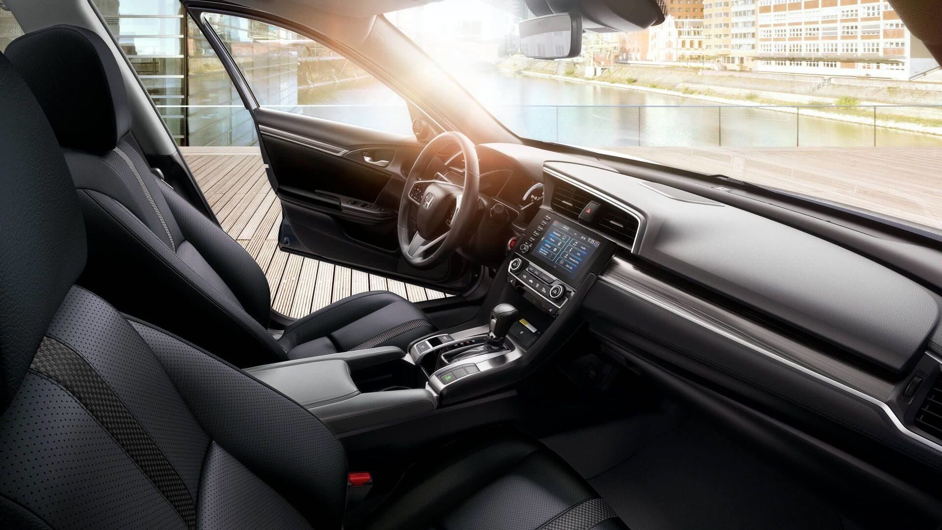 Front interior of the 2021 Honda Civic Sedan with the driver's door open