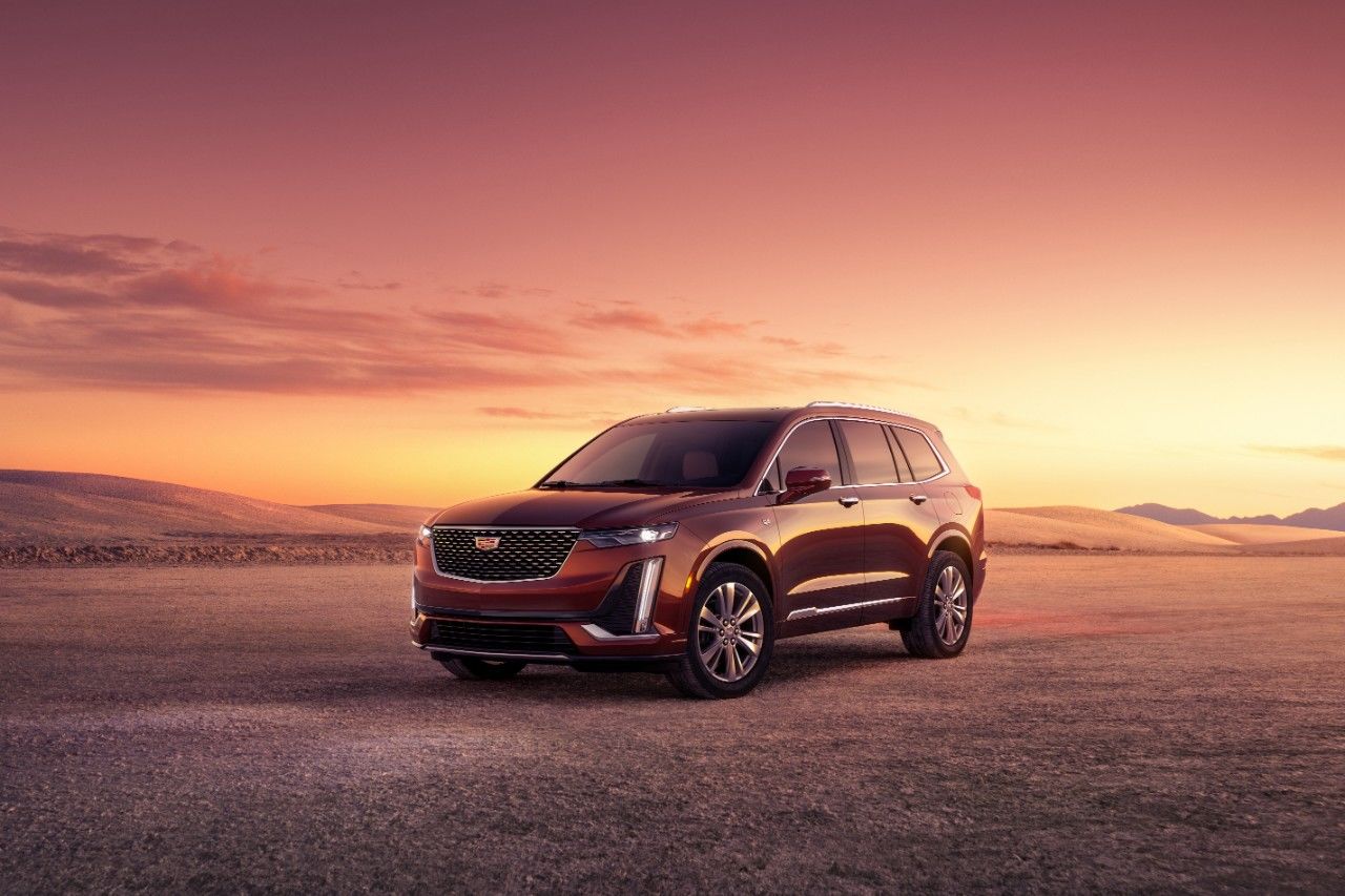 front side view of a 2023 Cadillac XT6 in the desert at dusk