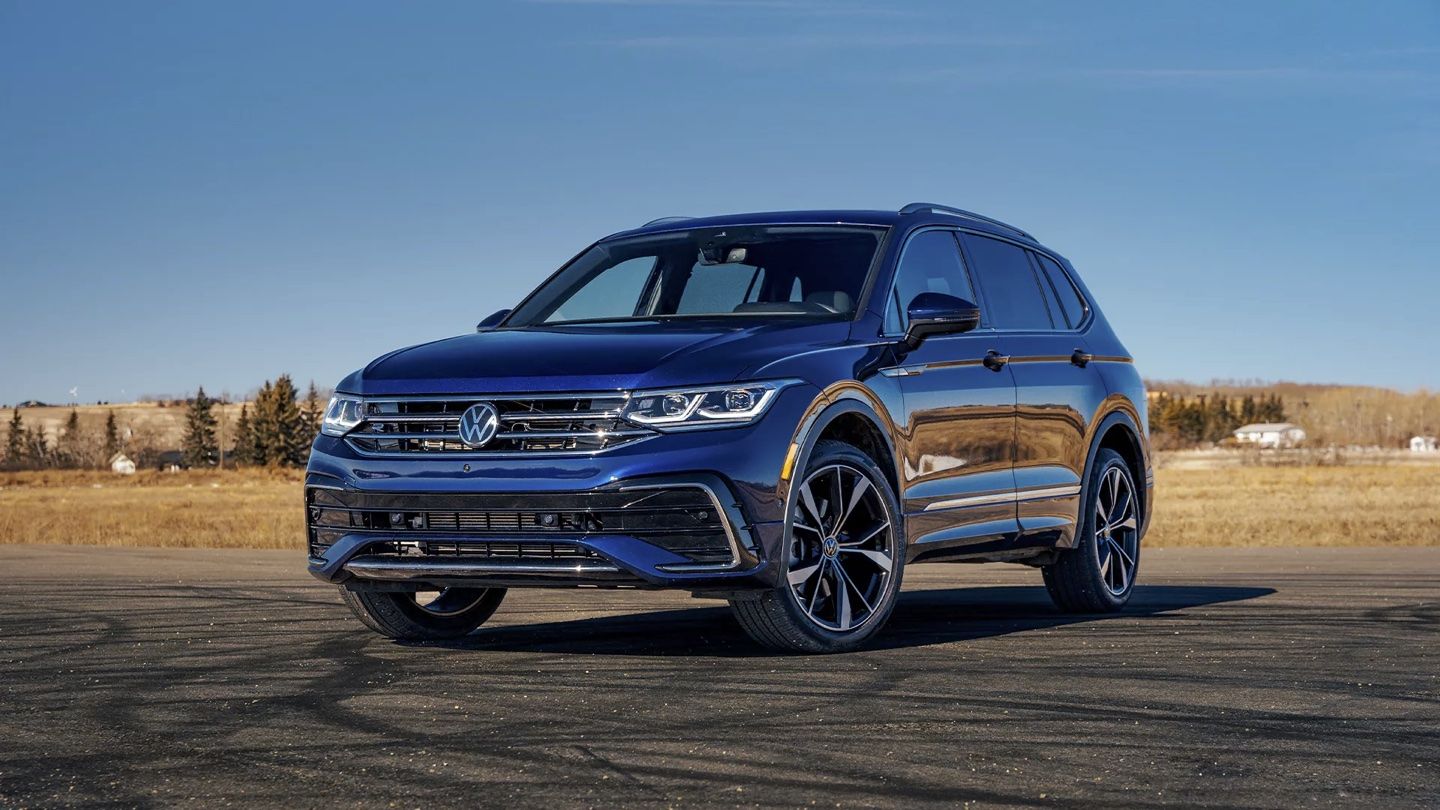 The Volkswagen Tiguan parked in front of a meadow.