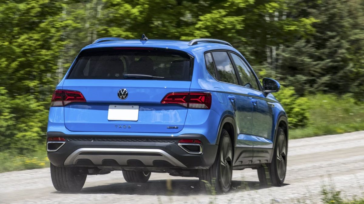 Rear view of the Volkswagen Taos 2024 on a gravel road.