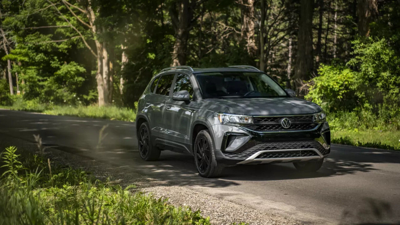 The Volkswagen Taos 2024 driving through a forest.