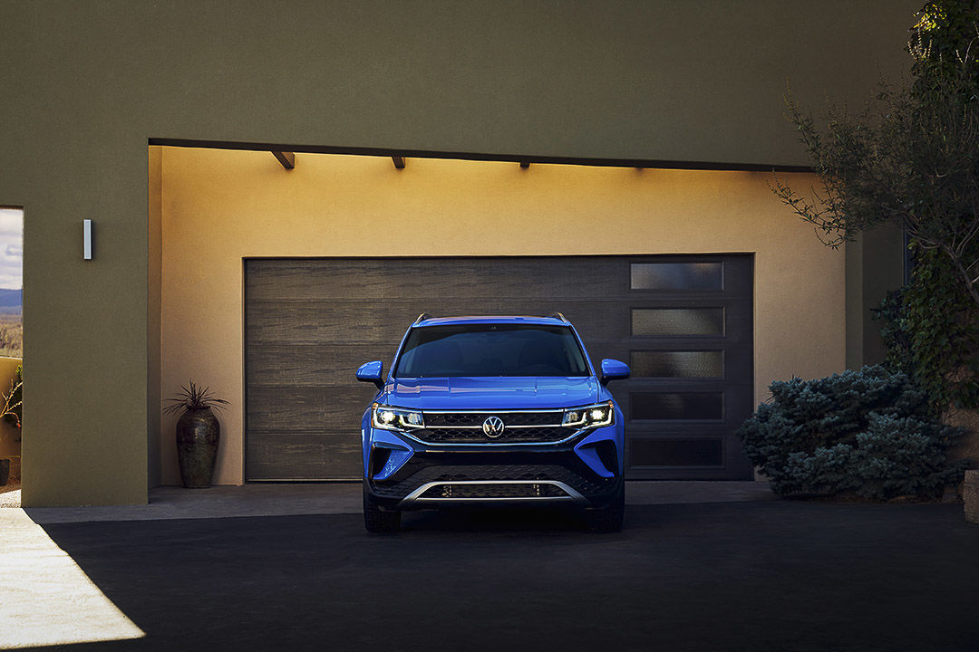 front view of the 2022 Volkswagen Taos parked in front of a house