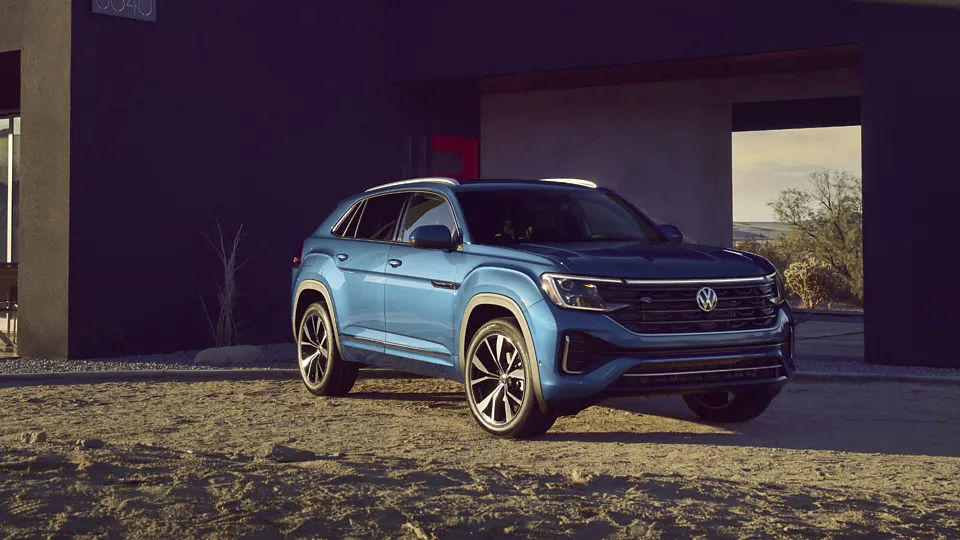 The Volkswagen Atlas Cross Sport 2024 parked on the porch of a residence.