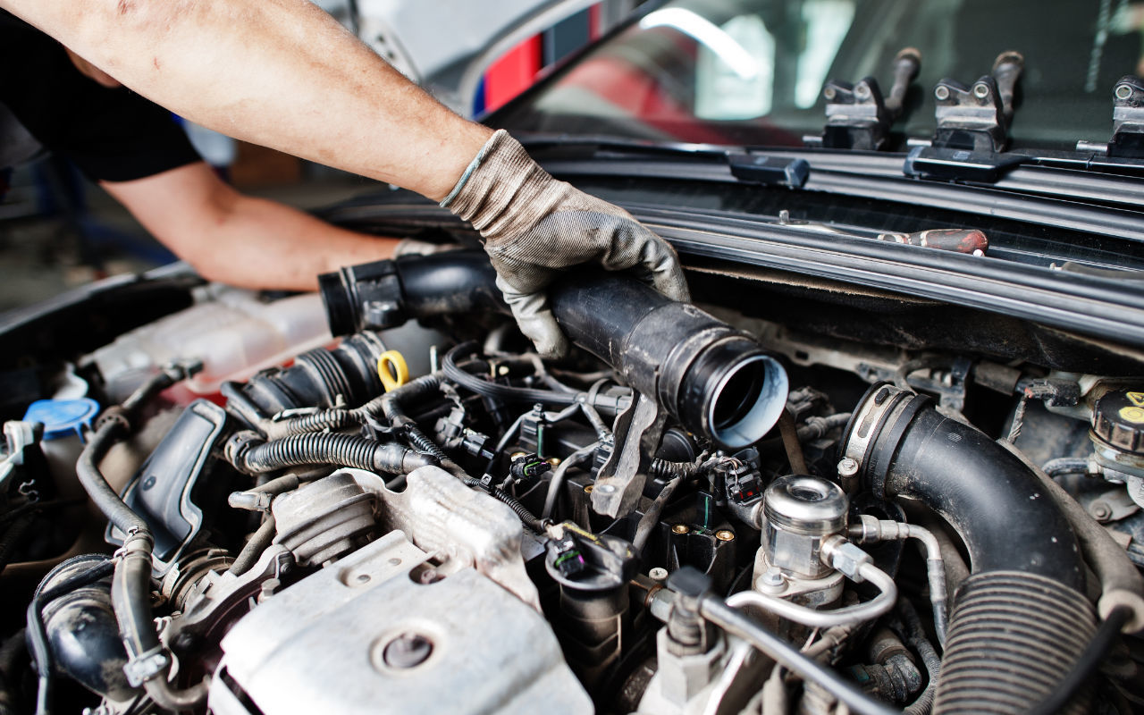 close up view of a mechanic doing maintenance on a car engine