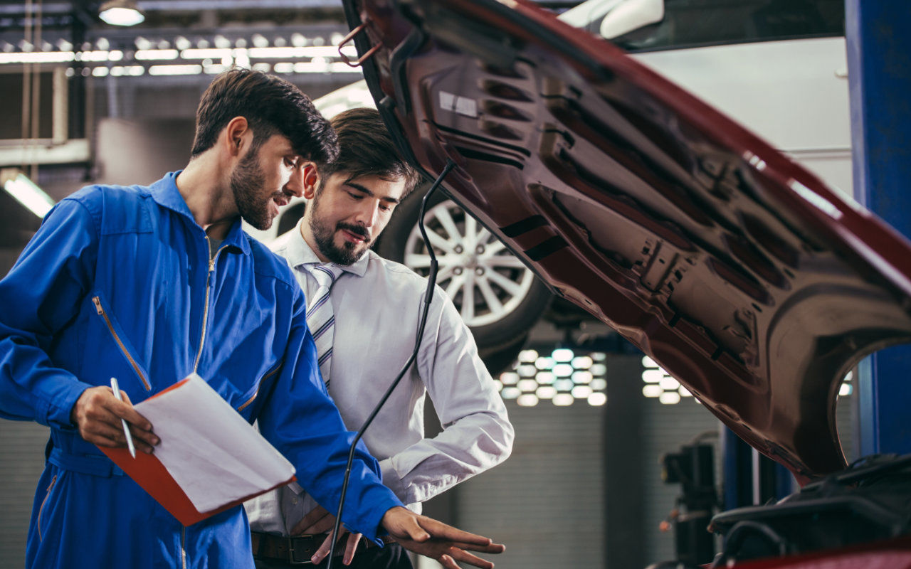 mechanic and customer inspecting a vehicle together
