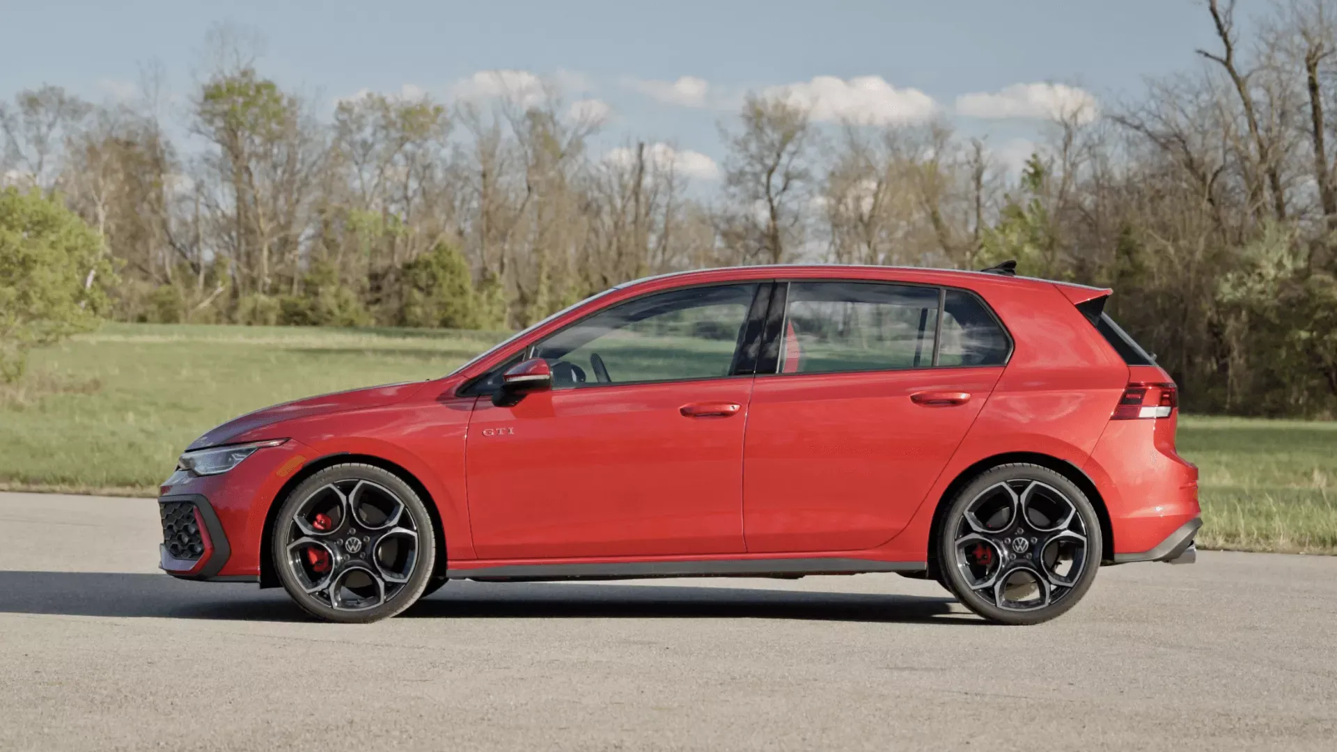 Side profile of the red 2026 Volkswagen Golf GTI.