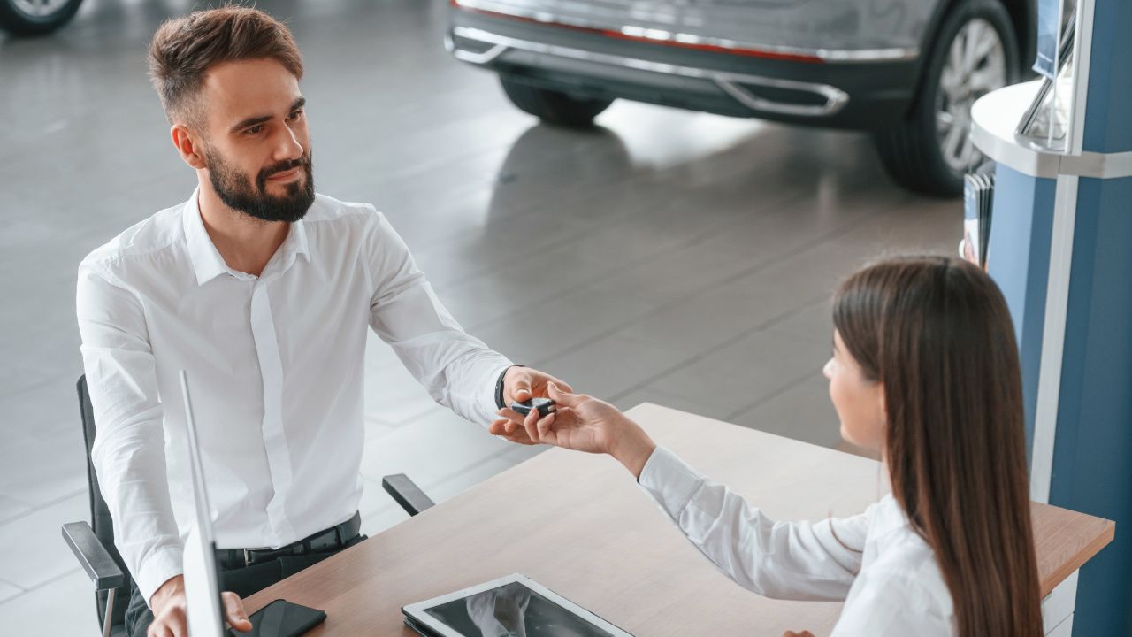 young man receiving his new car keys